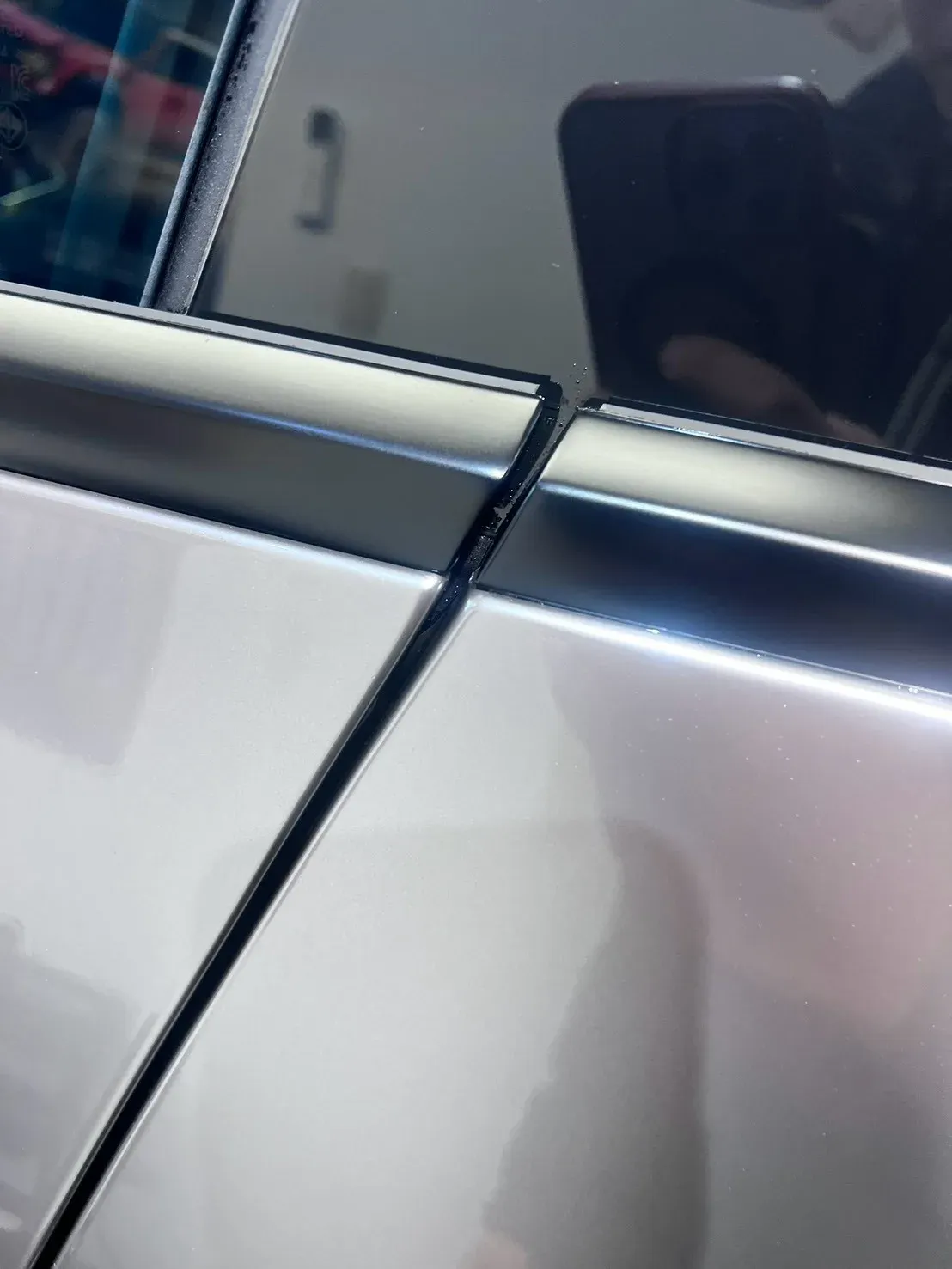 Tesla Model Y 液態金屬銀改色犀牛皮完工實拍（B 柱與車窗黑色飾條一帶）